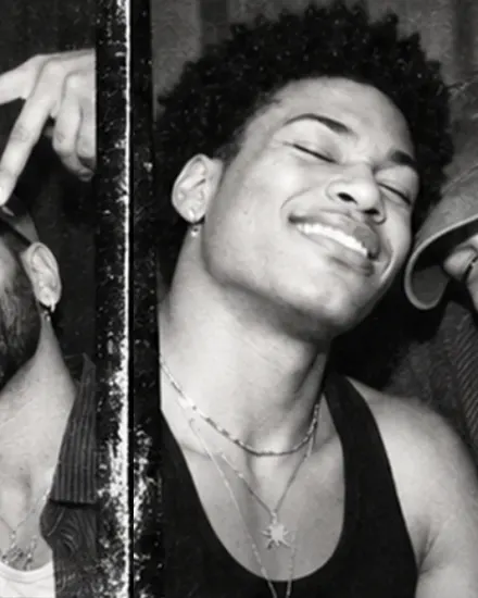 Three overlapping black-and-white photo booth strips show a woman and a man smiling and posing.